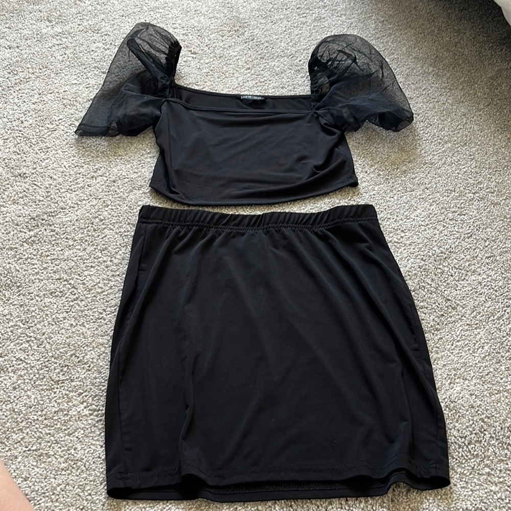 Black two piece set. Puffy, sheer sleeves. Crop top with skirt.